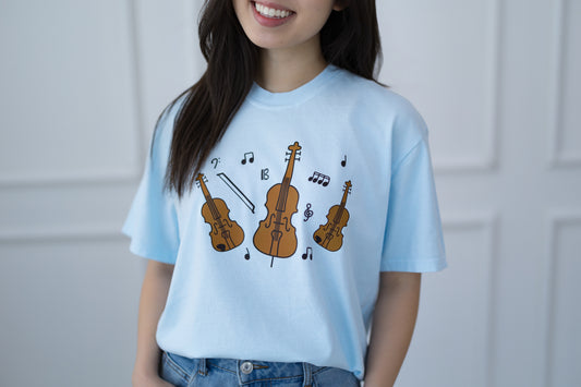Person wearing a light blue t-shirt with musical instrument designs.