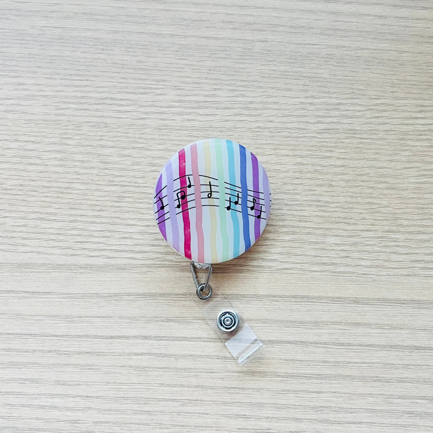 Multicolored striped badge holder on a textured surface
