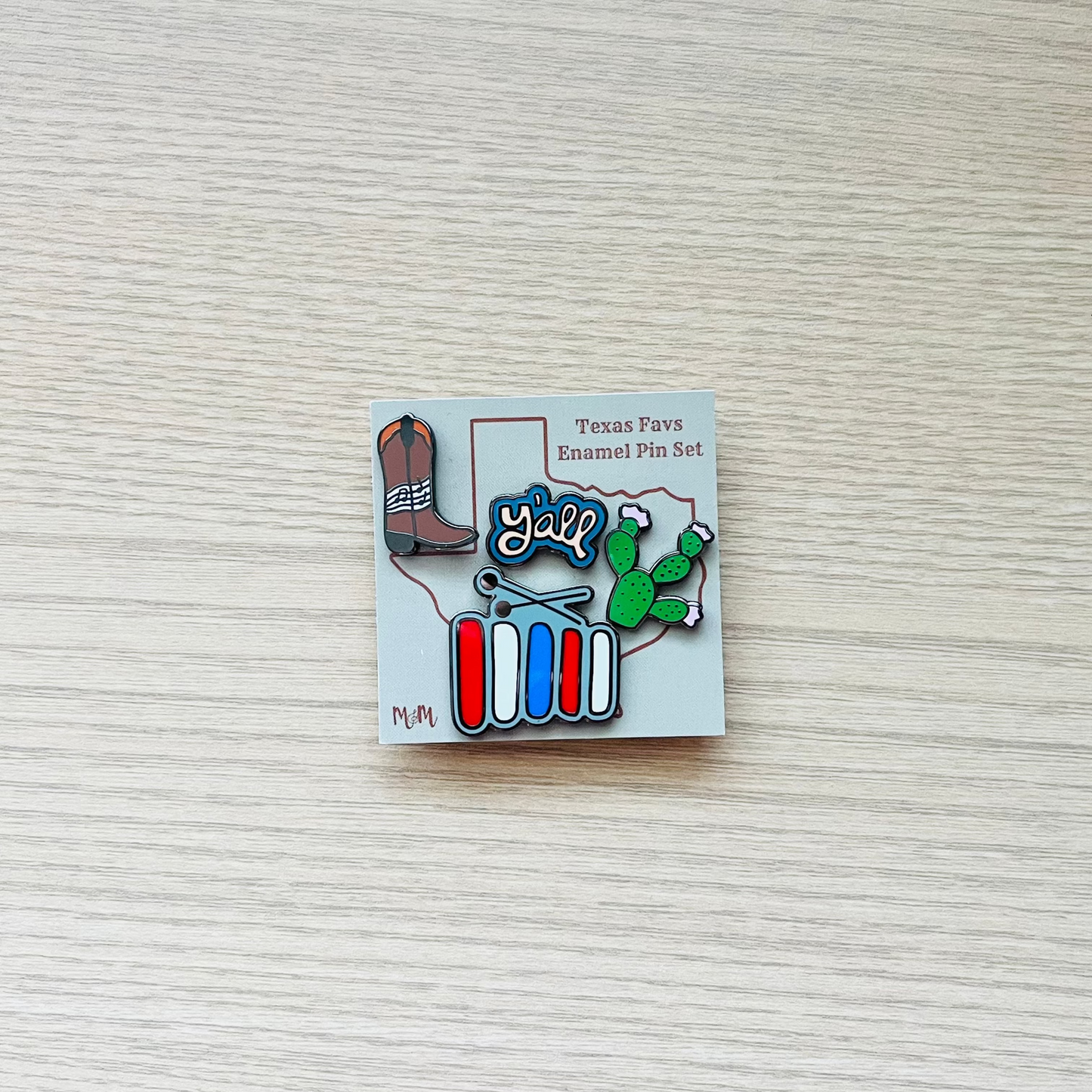 Pin with cartoon character and text on a textured surface