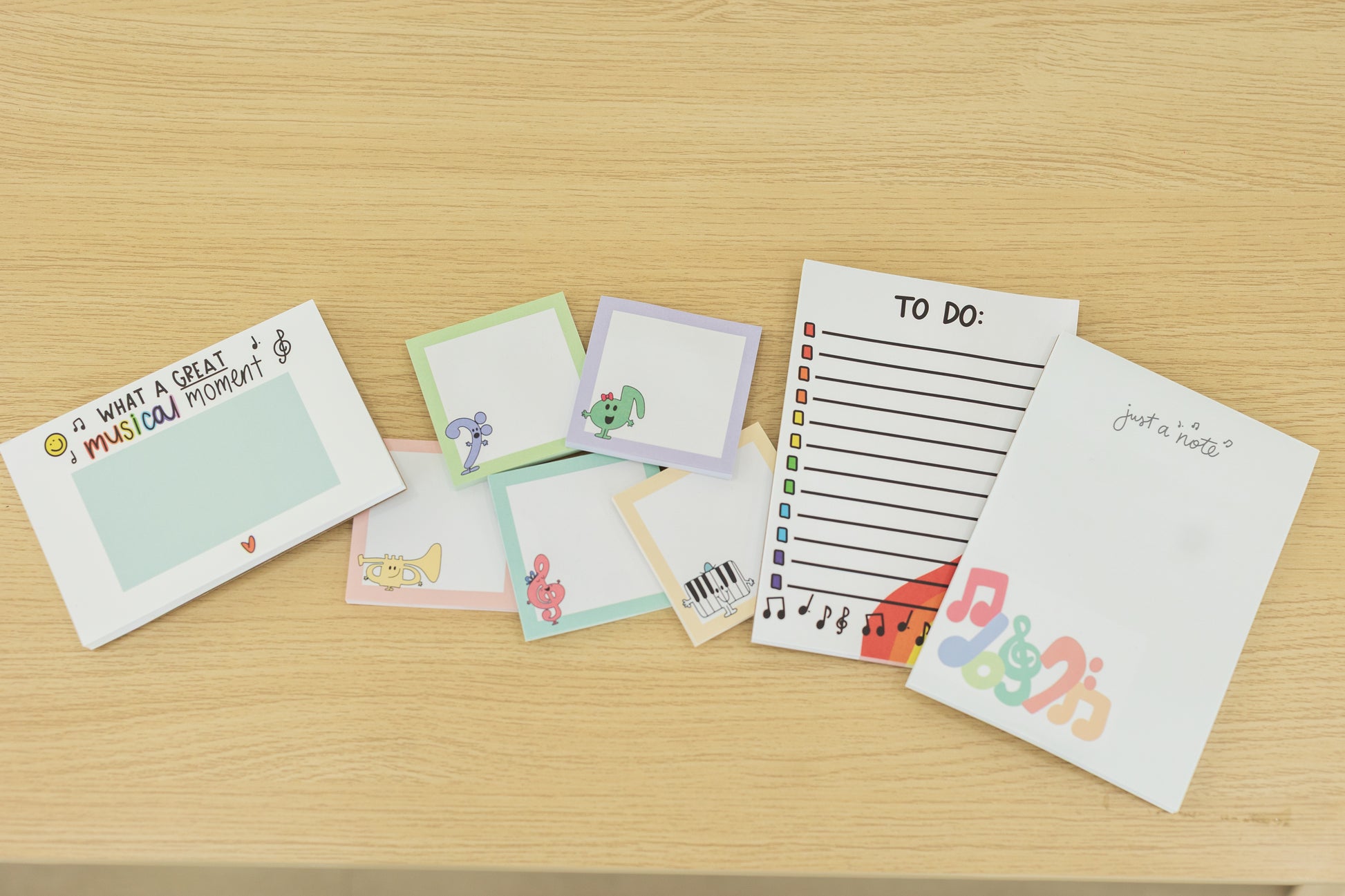 Collection of colorful stationery items on a wooden surface