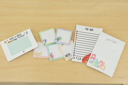 Collection of colorful stationery items on a wooden surface