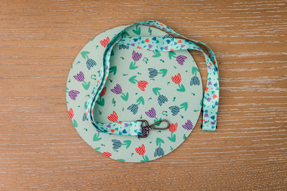 Music themed mousepad and lanyard with a tulip pattern on a wooden surface
