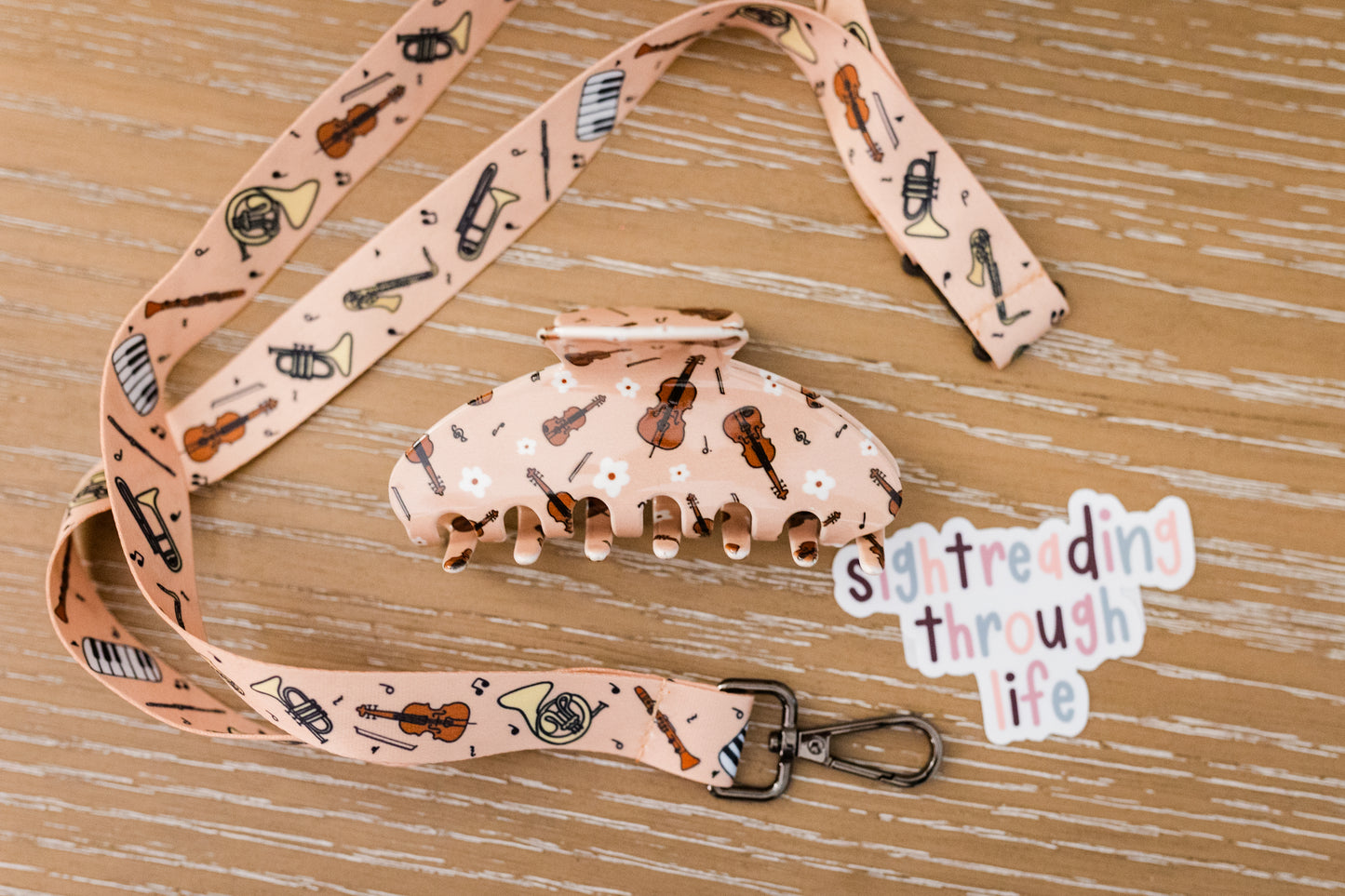 Lanyard and hair clip set with strings pattern on a wooden surface