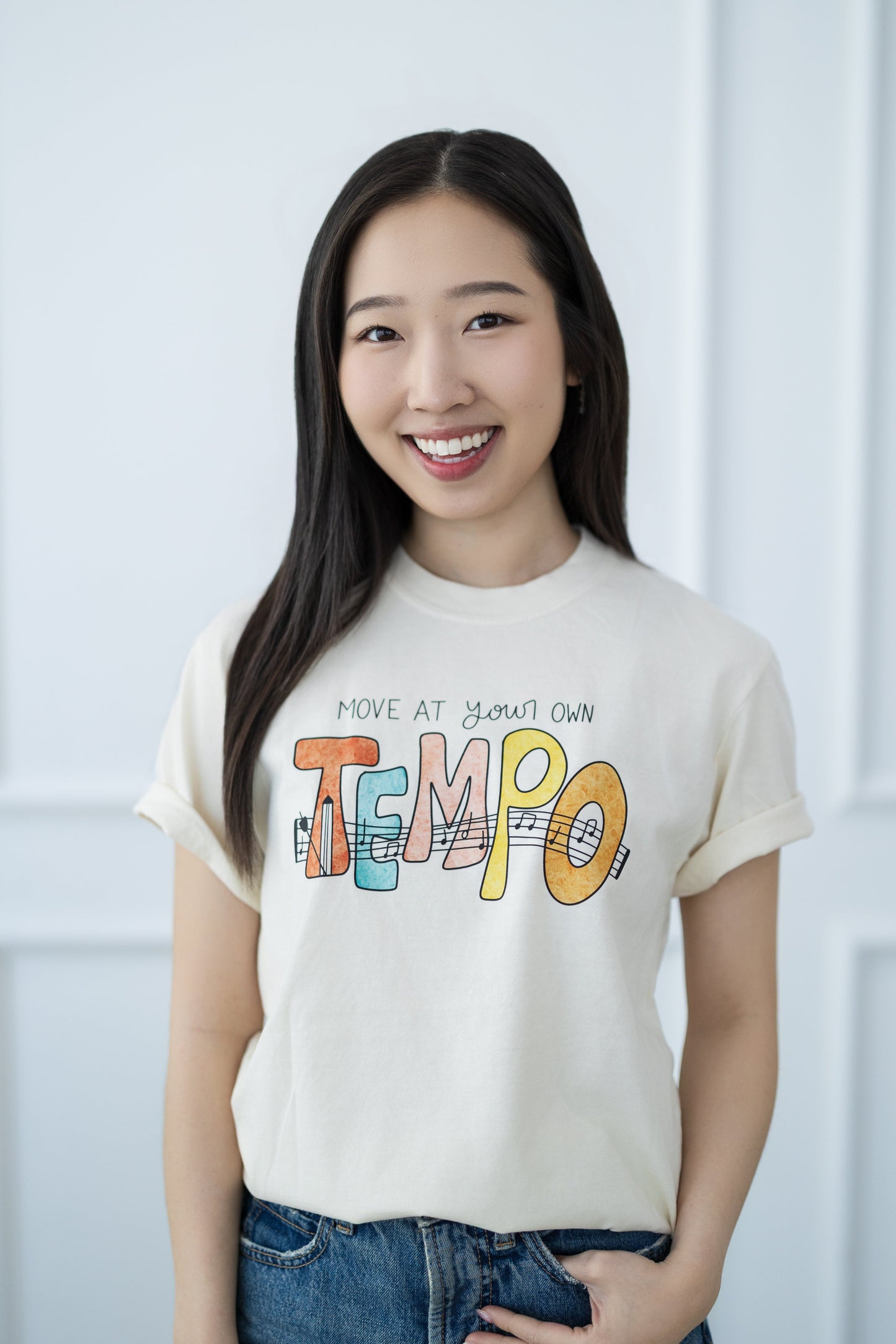 Woman wearing a t-shirt with colorful text against a white background