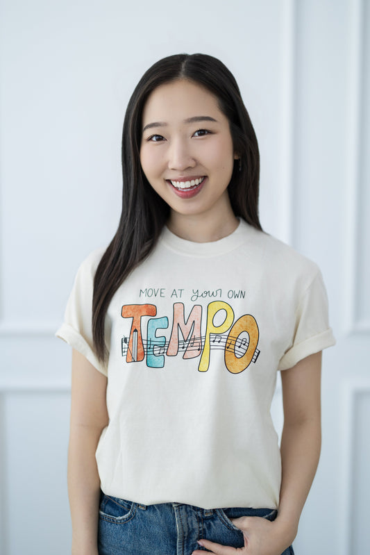 Woman wearing a t-shirt with colorful text against a white background