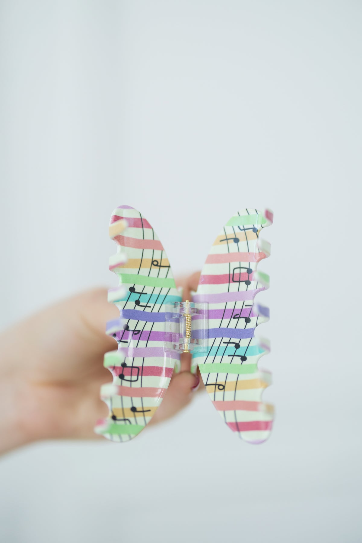 Open hair clip with colorful pattern on a white background