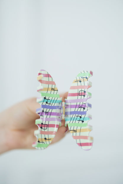 Open hair clip with colorful pattern on a white background