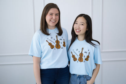 Two people wearing light blue t-shirts with musical instrument designs against a white background