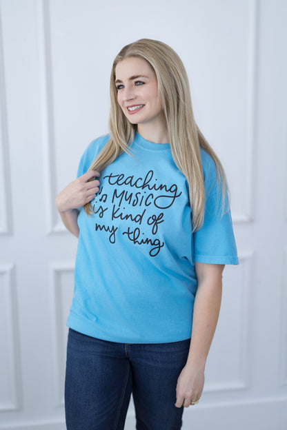 Woman wearing a blue t-shirt with text, standing against a white background