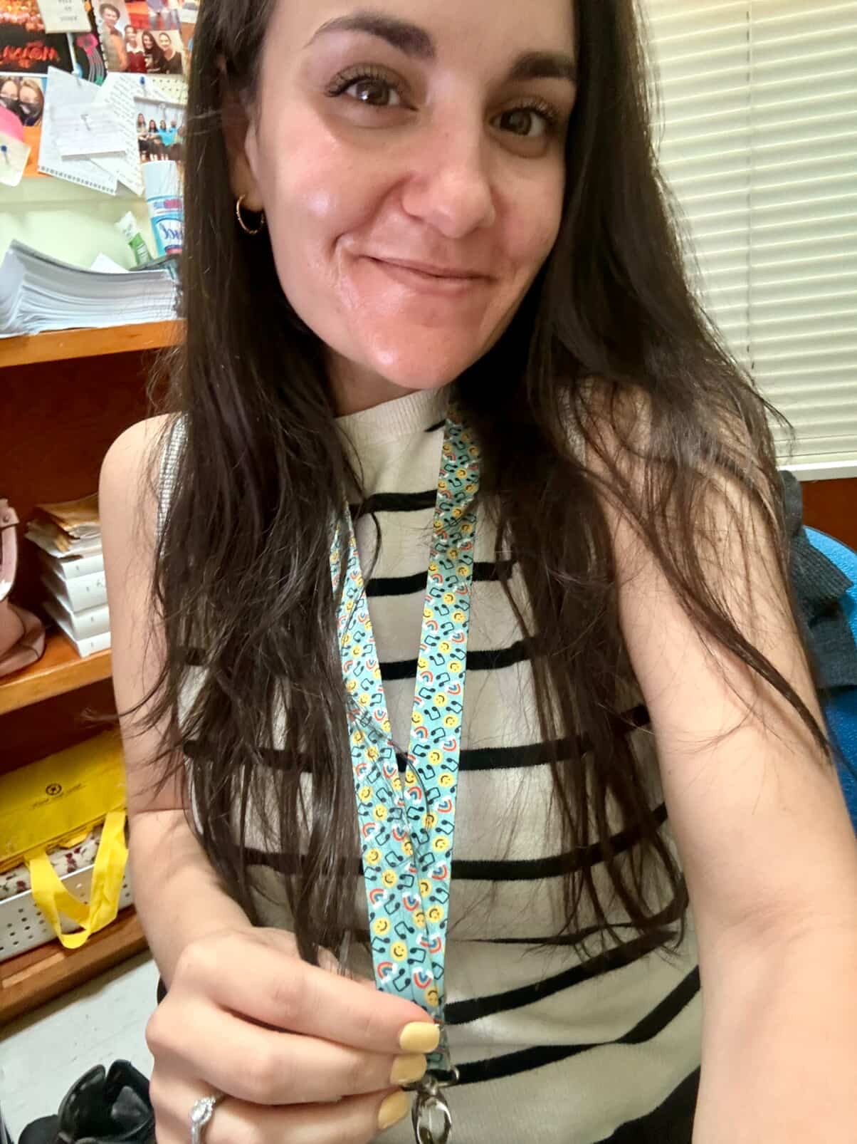 Woman holding a lanyard with a floral pattern in an indoor setting