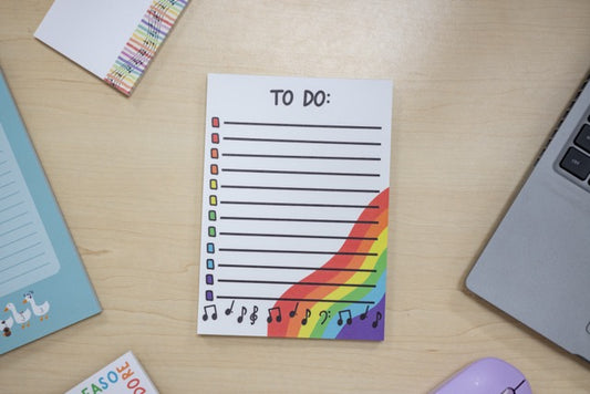 Colorful 'To Do' list notepad on a desk with stationery items.
